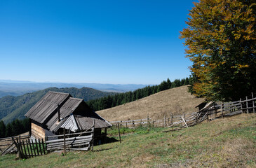 Wooden house in the mountains with a view of the plateau behind. Golija mountains in Serbia
