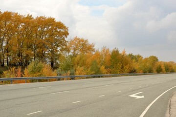 The high-speed track of the test site with yellowed trees behind the fence