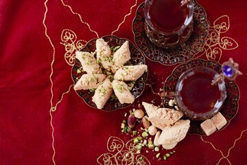 Traditional sweet food with tea and nuts Ramadan food