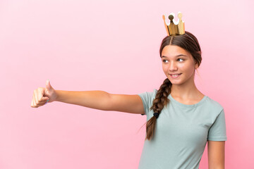 Little caucasian princess girl isolated on pink background giving a thumbs up gesture