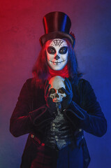 Handsome man with scary Halloween make up dead day calavera style with skull