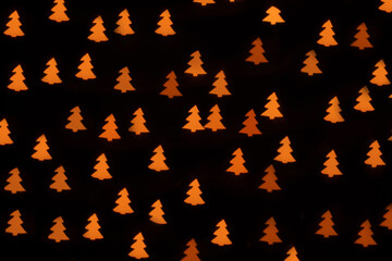Christmas tree bokeh light on background, pattern, dark background.