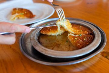 Turkish dessert kunefe, kunafa, kadayif with pistachio powder and cheese, served hot, very sweet.