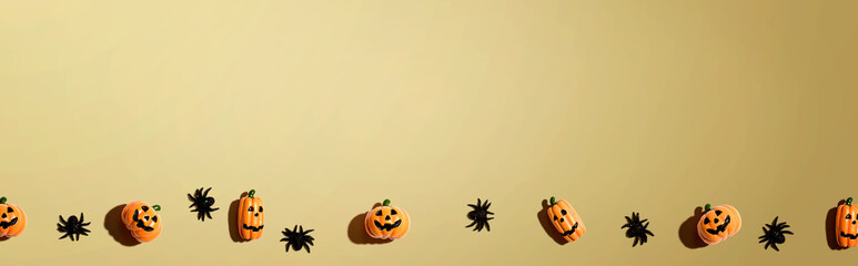 Miniature Halloween pumpkin ghosts with spiders - flat lay