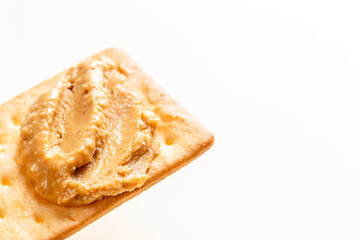 Peanut butter spread on soda crackers close up