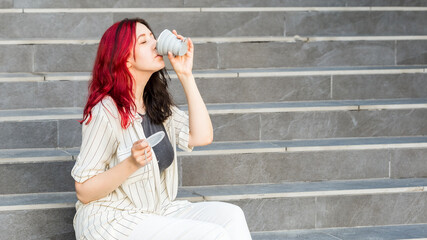 Woman holding a reusable silicone collapsible cup