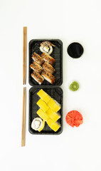 Sushi delivery box on white background. Japan menu in black transport box