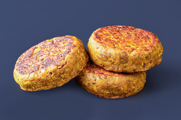 three vegan burgers, patties on black background
