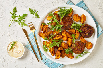 vegan lentil patties with baked potato and hummus