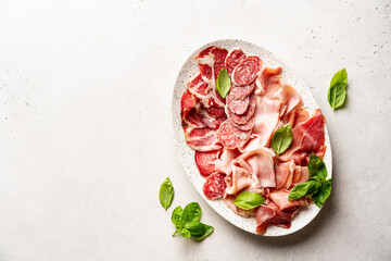 Appetizers with differents antipasti, charcuterie, snacks and red wine on white background....