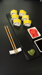 Sushi selection on black slate, food border background