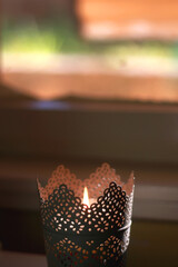 Candle holder with lit candle. Selective focus.