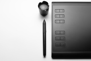 Graphic tablet with pen for illustrators and designers on white background. Copy space. © proton_l3