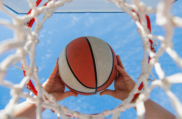 basketball ball flying through basket in players hands, sport © Olena
