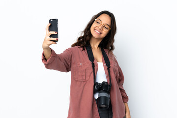 Young photographer woman over isolated white background making a selfie