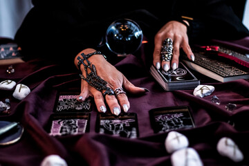 caucasian witch reading magic tarot card and divination crystall ball