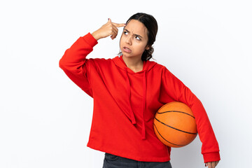 Young woman playing basketball over isolated white background making the gesture of madness putting...