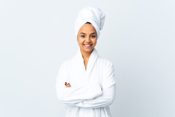 Young woman in bathrobe over isolated white background keeping the arms crossed in frontal position