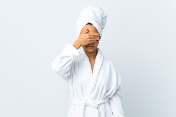 Young woman in bathrobe over isolated white background covering eyes by hands. Do not want to see something