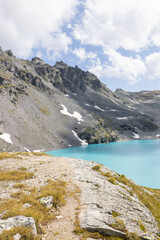 Amazing hiking day in one of the most beautiful area in Switzerland called Pizol in the canton of Saint Gallen. A wonderful view at the alpine lake called Wildsee with a tent by the lake. Epic view.