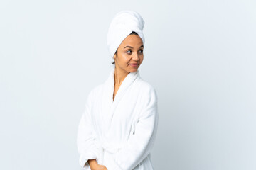 Young woman in bathrobe over isolated white background . Portrait