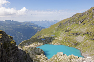 Fototapeta na wymiar Amazing hiking day in one of the most beautiful area in Switzerland called Pizol in the canton of Saint Gallen. What a wonderful view to a clear blue alpine lake called Schottensee.