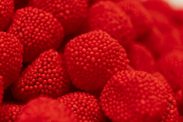 Red sweet jelly like berries and candies with sugar. Macro.