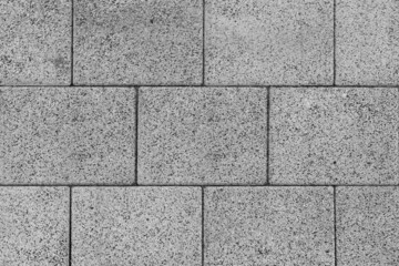 The texture of the large gray brick blocks lined up in layers. Or as a brick block used in construction can be used as a background in architecture or house building.