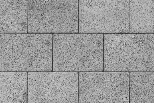 Fototapeta The texture of the large gray brick blocks lined up in layers. Or as a brick block used in construction can be used as a background in architecture or house building.