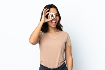 Young woman over isolated white background holding a donut and happy