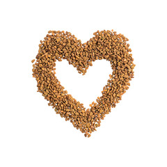Bunch of fenugreek brown dry seeds or grains arranged in a heart shape used as ingredient for preparation of helba tea or cooking food, also in local medicine of Egypt isolated on white background