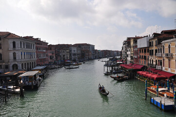 Fototapeta premium Panoramic view of the canal with a pier along the embankment. Gondolas float along the canal. ... October 11, 2014, Venice, Italy
