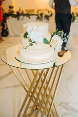 Amazing three-story wedding cake decorated with flowers