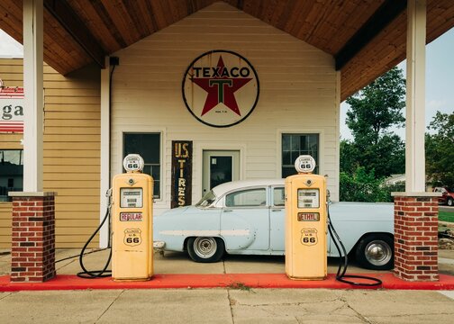 Old gas pumps and vintage car at Franks Old Station, on Route 66 in Williamsville, Illinois