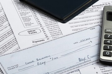 Tax Documents with Calculator and Cheque