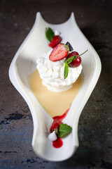 meringue dessert with strawberries in a stylish white plate