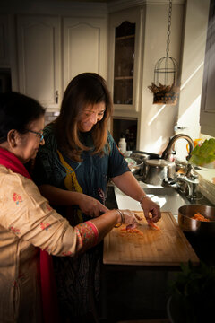Mother teaching daughter cooking 