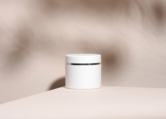 white jar for cosmetics on a beige table. Packaging for cream, gel, serum, advertising and product promotion, mock up