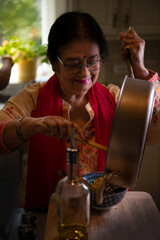 Indian woman cooking in the kitchen 