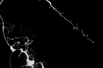 White paint splash isolated on black background.