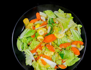 Cloae up of vegetable stir fry with carrots, onions, zucchine and chinese cabbage