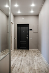 Spacious entrance hall in the apartment with built-in wardrobe and mirrors