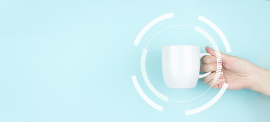 Morning download. Girl hand hold morning coffee cup with mock up circular diagram . Copy space. Blue background.