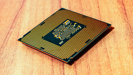 the computer chip lies on a wooden table.  Computer elements.  old processor.  Computer techologies...