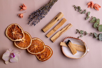 Ritual objects for meditation, relaxation and aromatherapy Palo Santo sticks, candle, natural plant aromas. Top view, flat lay, copy space.