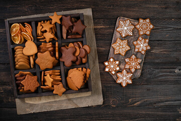 Collection of various gingerbread cookies in a box on wooden background