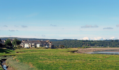 view of the village of arnside from the bank of the river kent with surrounding lakeland scenery