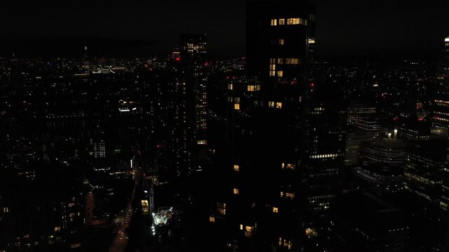 tall apartment building with seldom lighted windows. Aerial view of modern borough