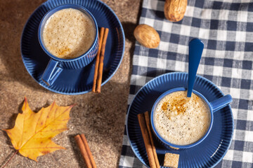 Blue cups with coffee, cappuccino with cinnamon, autumn coffee concept, hot drinks, warm home atmosphere