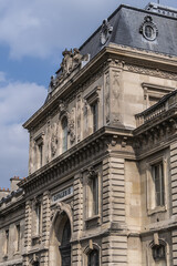 Architectural fragment of the facade of the military school (Ecole Militaire) founded in 1750 in Paris. Cavalry (Cavalerie) building. Paris, France.